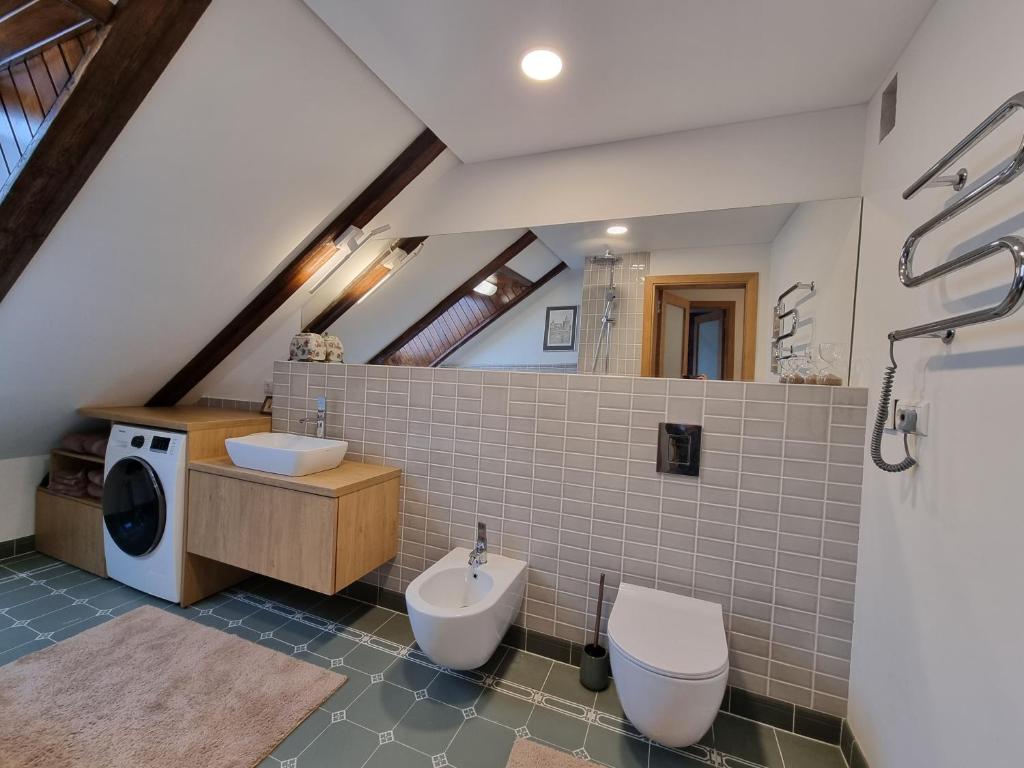 Bathroom with washing machine and large mirror
