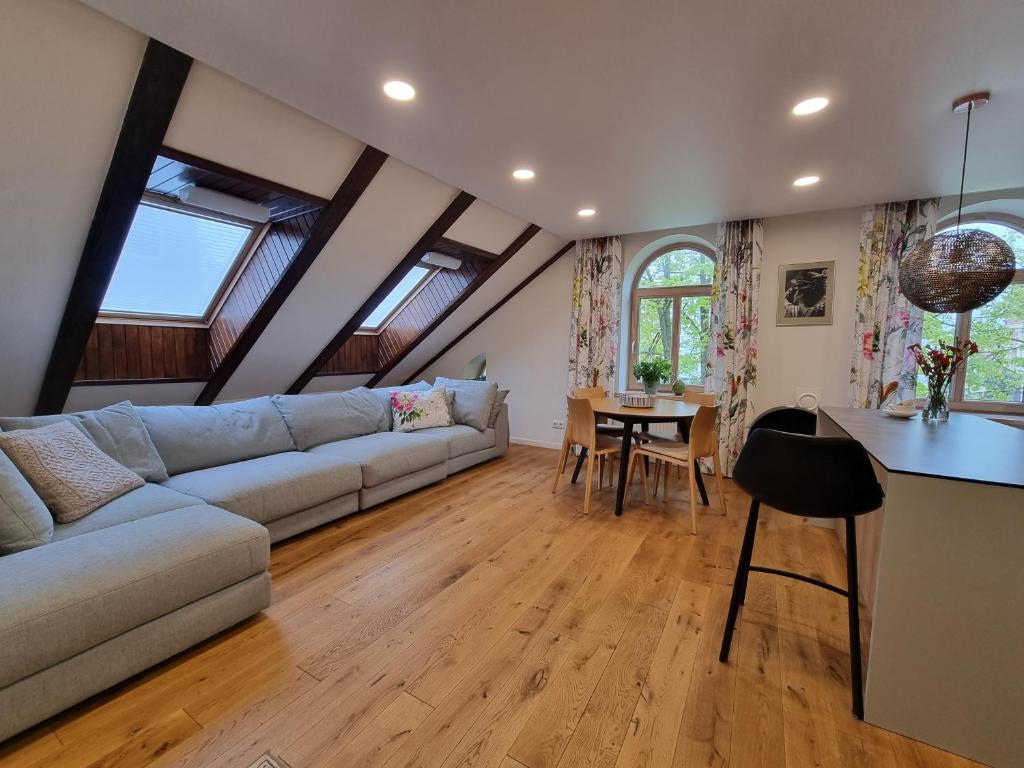Spacious living room with large sofa and skylights